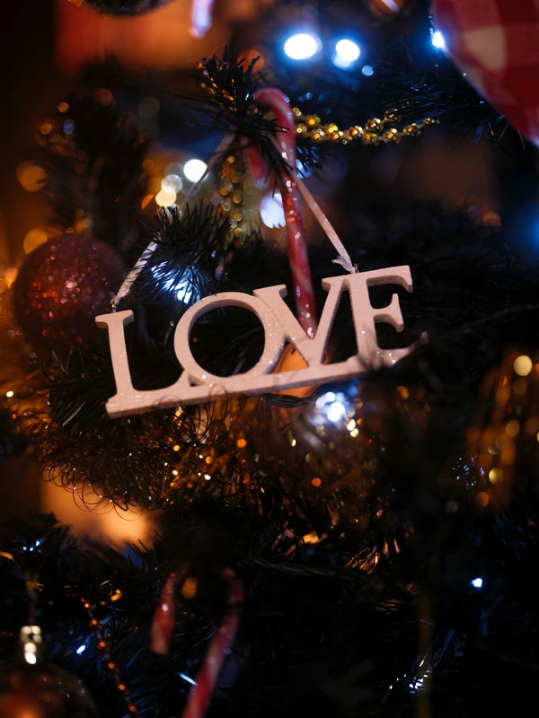 A close up of a christmas tree with the word love on it