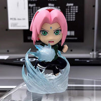 Action figure with pink hair and green eyes, surrounded by a blue energy effect, on a reflective surface.