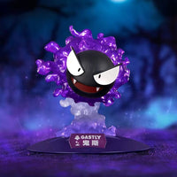 Gastly figure from Pokémon with a purple aura on a dark background