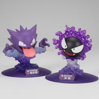 Two purple animated character figurines on a gray background