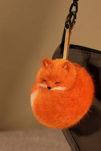 Red and white Kudoll sleeping fox plush keychain with cute fox face and soft fabric, perfect as a bag charm or accessory.