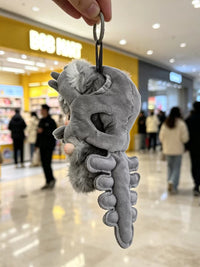 Pop Mart DIMOO and Labubu dinosaur skeleton plush bag charm keychains with colorful dinosaur-themed designs