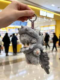 Pop Mart DIMOO and Labubu Dinosaur Skeleton plush bag charm keychains displayed together