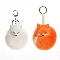 Red and white Kudoll sleeping fox plush keychain attached to a bag, featuring soft fabric and detailed fox face design.