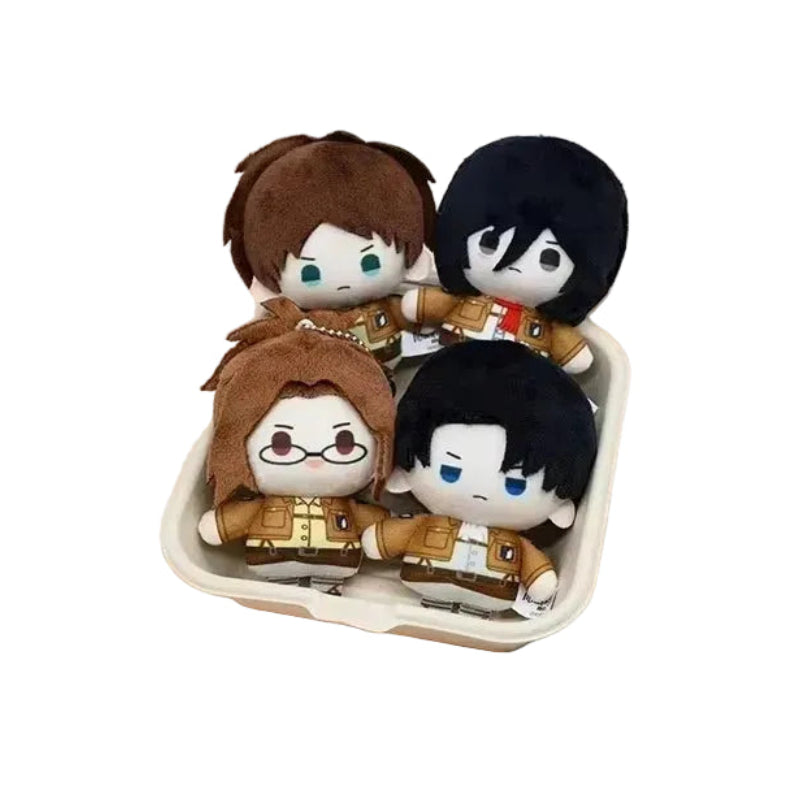 Plush toys of characters from 'Attack on Titan' in a box with a decorative border and licensed text.