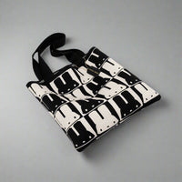 Black and white patterned bag on a gray background
