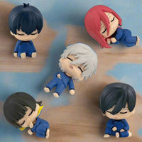 Five small figurines with different hairstyles and colors on a white background