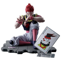 Figurine of a character with red hair and a card on a white background