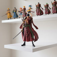 Action figure on a white shelf with other figures in the background