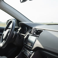 Car interior with steering wheel and dashboard view