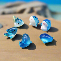 Set of blue dolphin-shaped figurines on a yellow background with 'JIQING HU' branding.